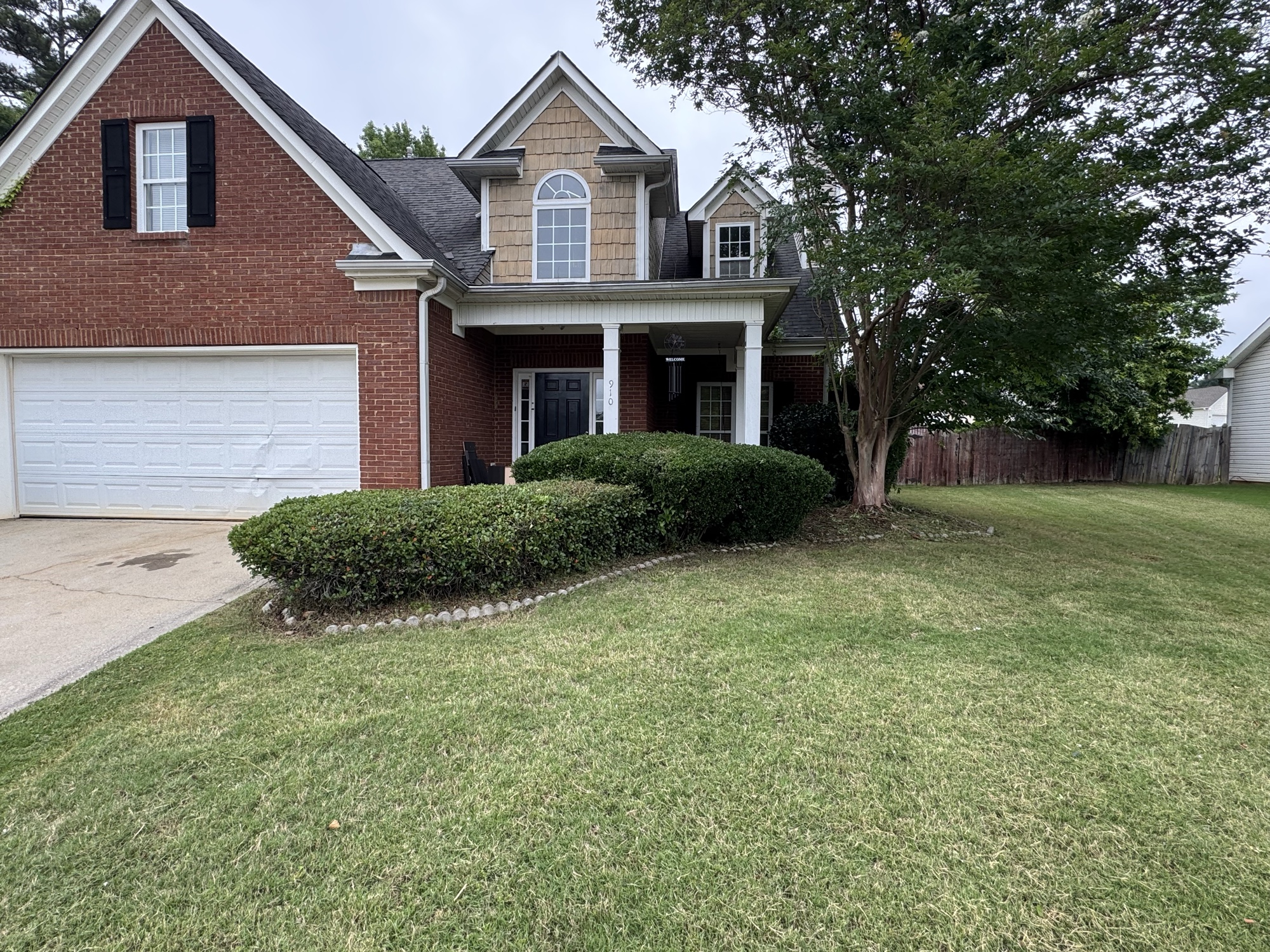 After: cleaned front yard with trimmed shrubs