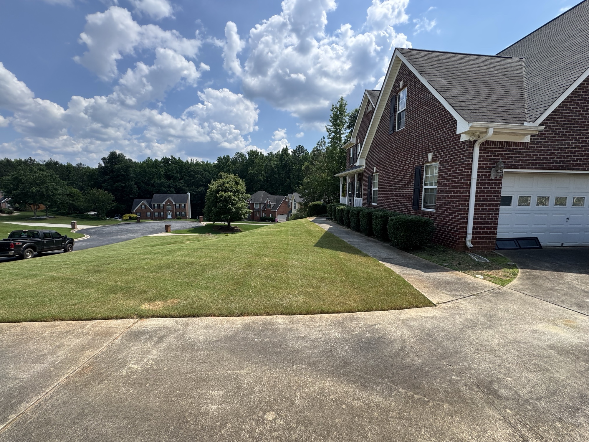 Freshly mowed and edged front yard at brick home