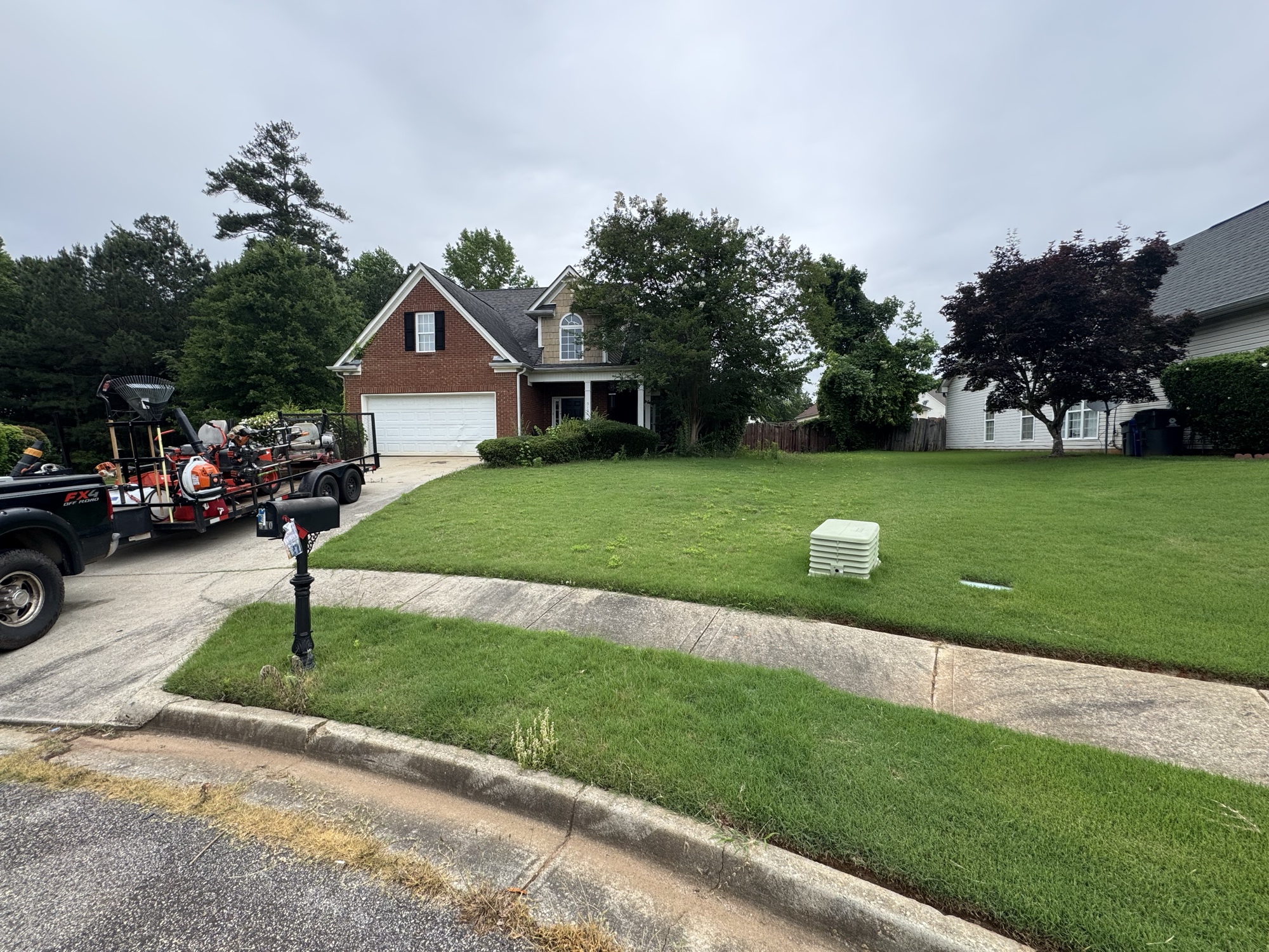 Mowed front yard of brick home
